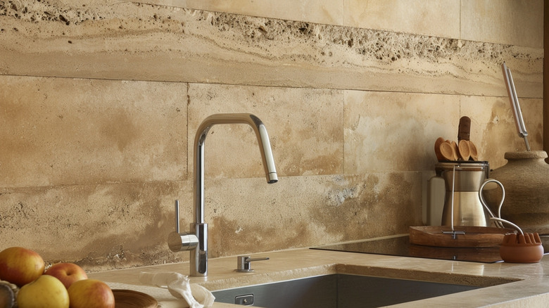 A travertine backsplash and countertop in kitchen