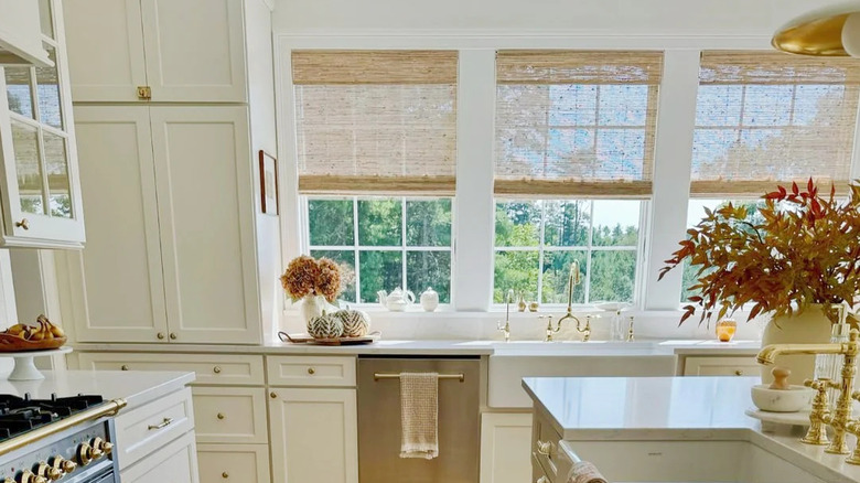 A kitchen with woven bamboo Roman shades