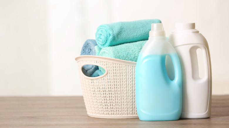 laundry detergent by basket with towels