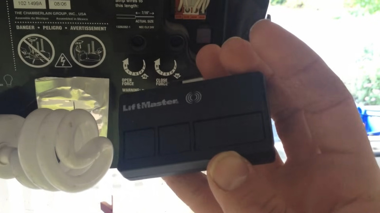 A person reprogramming their garage door remote