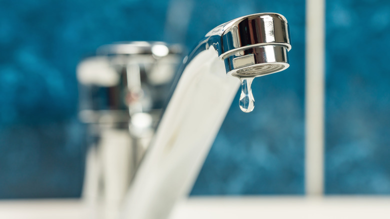 A close up of a leaky faucet