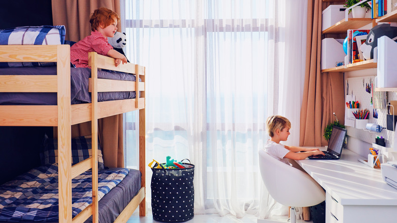 child laying on bunk bed