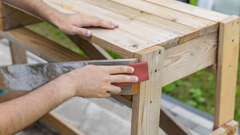 Person sanding wooden furniture