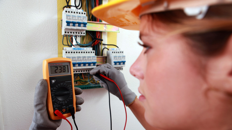 Electrician reading a multimeter