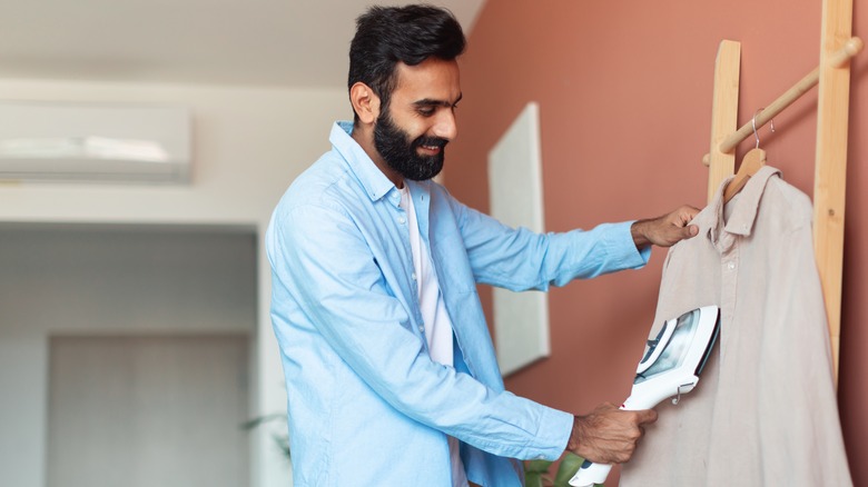 smiling man steaming shirt