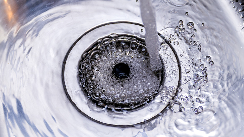 Water flowing into kitchen sink