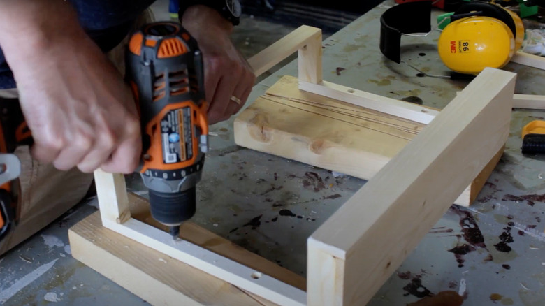 Man building a wooden cabinet door caddy