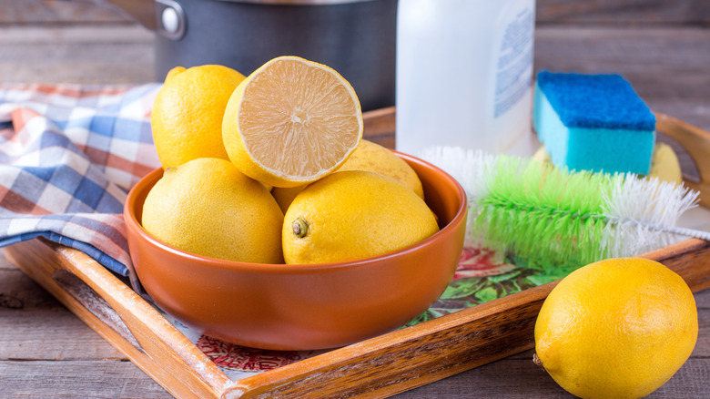 lemons in bowl with cleaning products