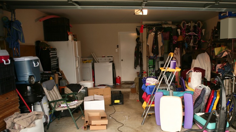 Messy garage with washer and dryer