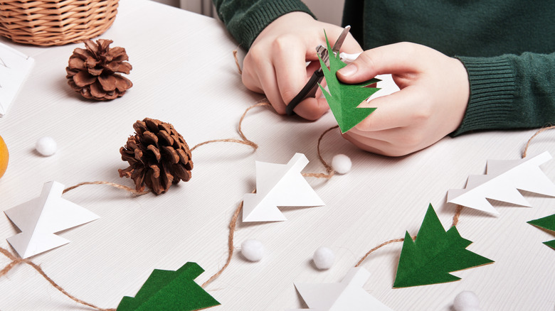 person DIYing paper garland