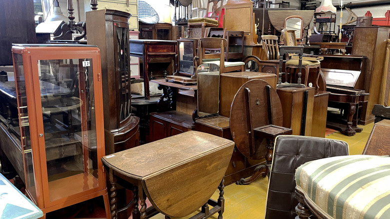 Thrift store aisle with wood furniture