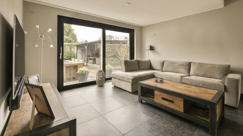 a modern living room with large sliding glass doors