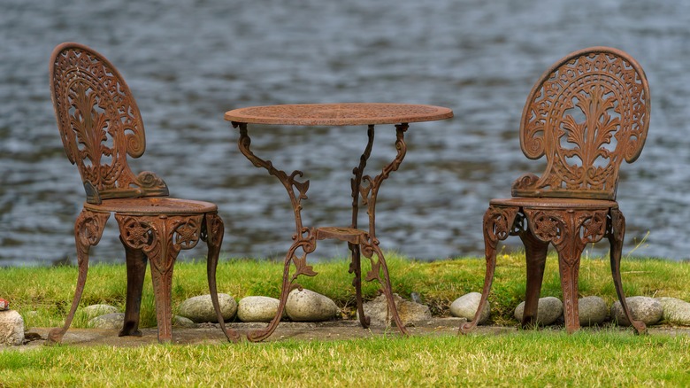 rusty chairs and table on lawn