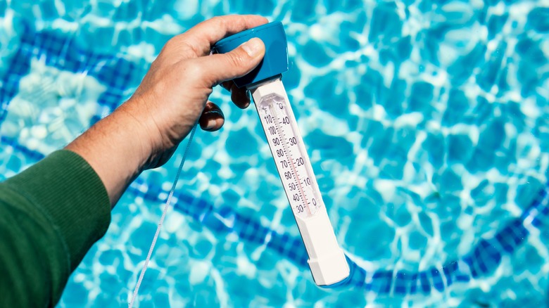 Thermometer checking pool temperature