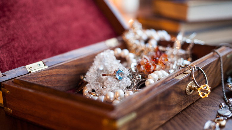 Wooden box filled with jewelry