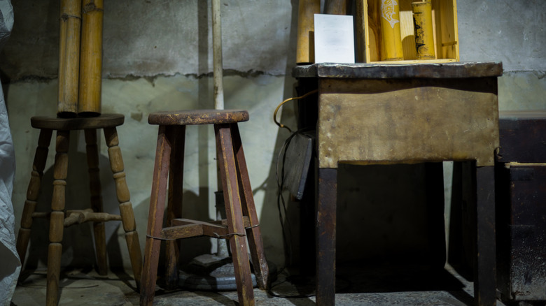 Old unused stools are stored in a basement.