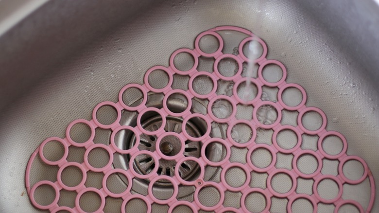 sink with pink rubber mat