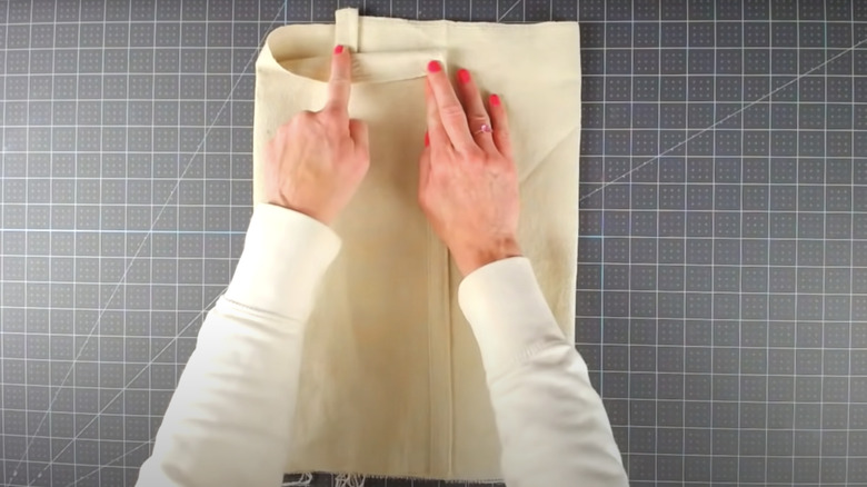 hands folding drop cloth pillowcase