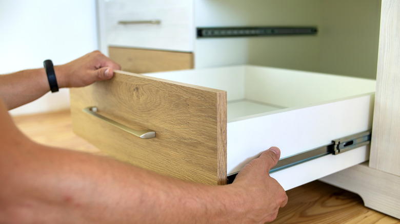 Light wood dresser drawer pulled open