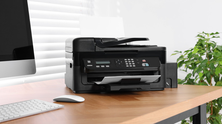 Printer and computer on home office desk