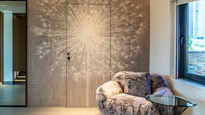 A hidden door and accent wall seamless covered in wallpaper.