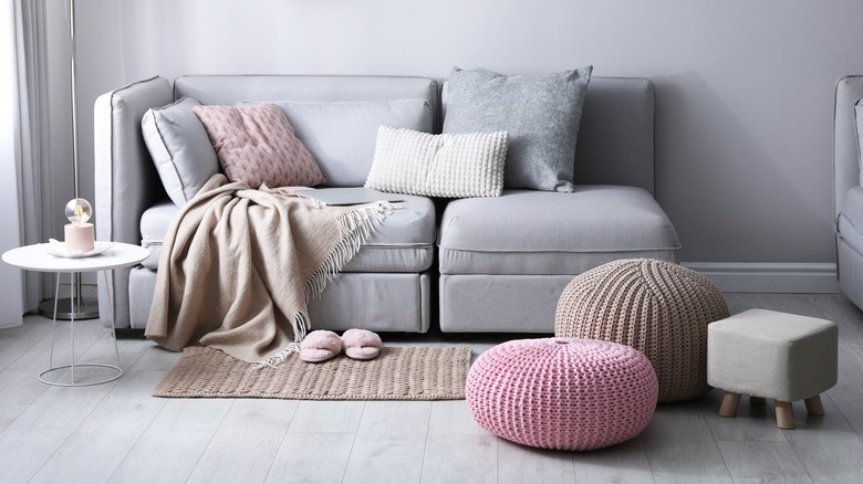 cozy sofa, ottoman, and poofs