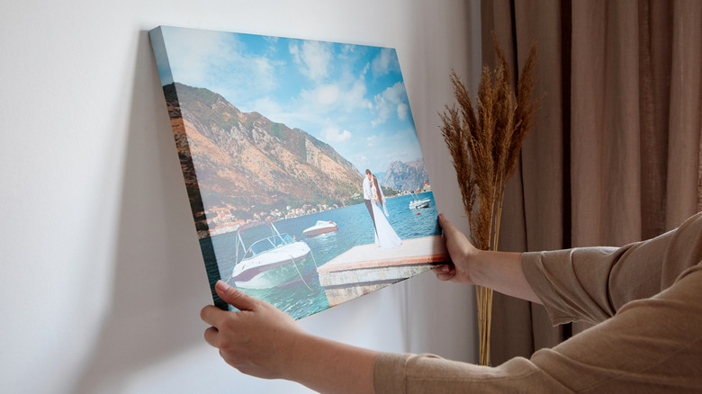 Person holding canvas art