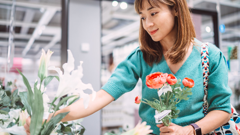 Someone looking through a selection of faux flowers