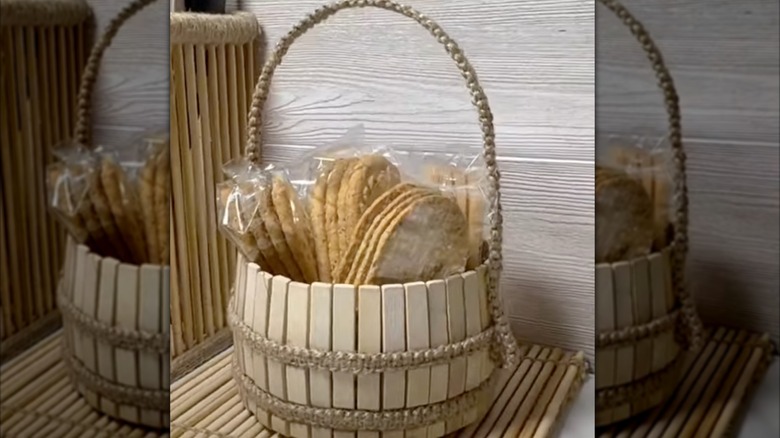 DIY wood basket made from clothespins, plastic bottle, and twine