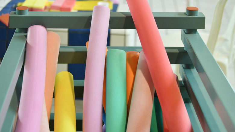 A bin full of colorful pool noodles