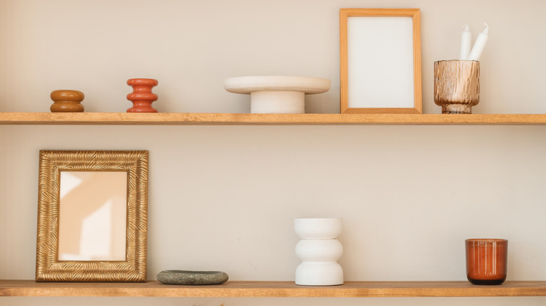 Collection of small decor pieces sitting on wall shelves