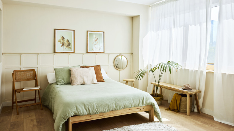 A bedroom has an accent wall and shelving