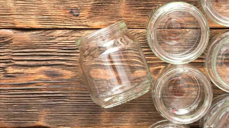 empty baby food jars lying on wood surface