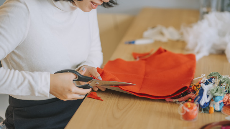 person cutting fabric