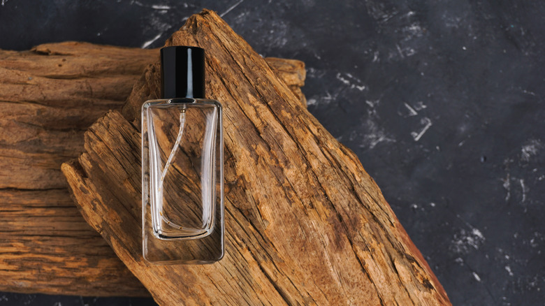 Empty perfume bottle on wooden board