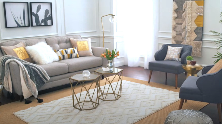 White rug layered over yellow rug in living room