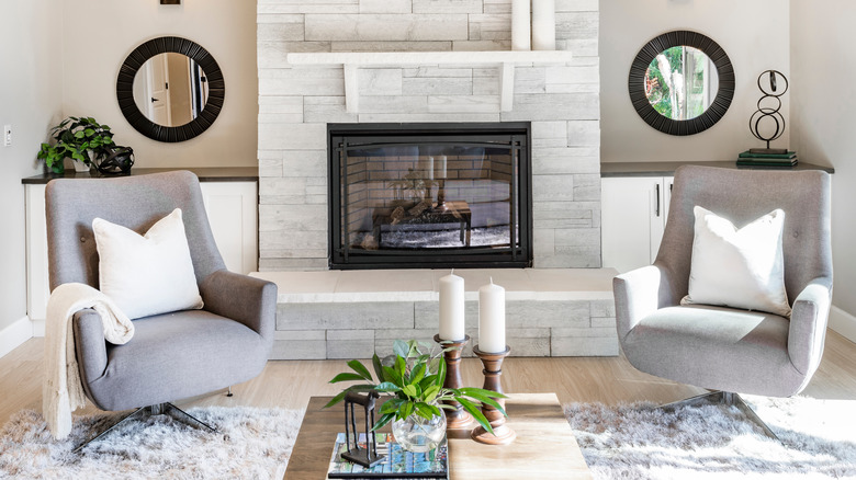 Fireplace flanked by two easy chairs