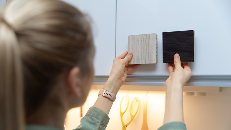 woman sampling kitchen cabinet styles