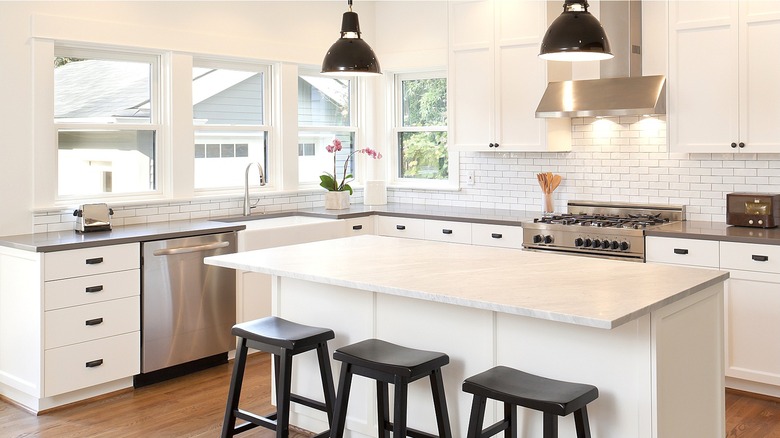 White kitchen with steel appliances