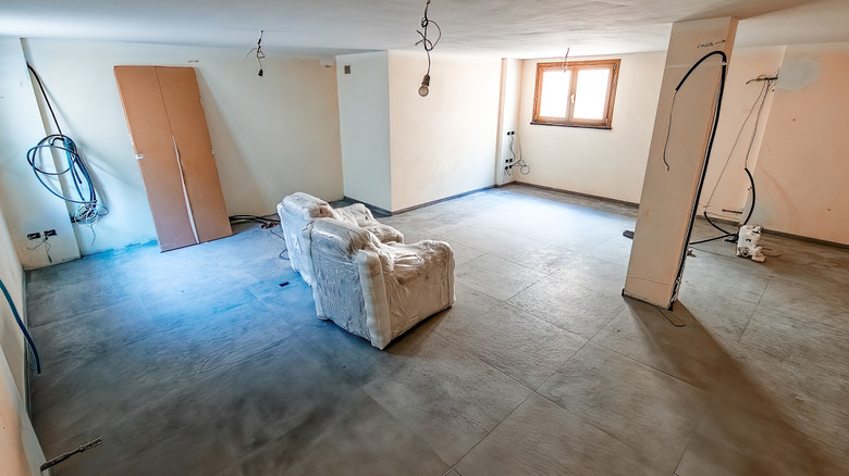 Basement room under construction with concrete floor finish applied