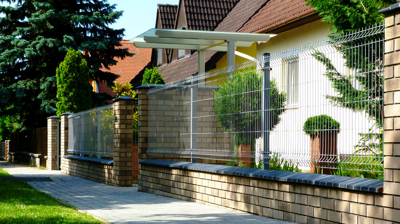 house with metal mesh fence