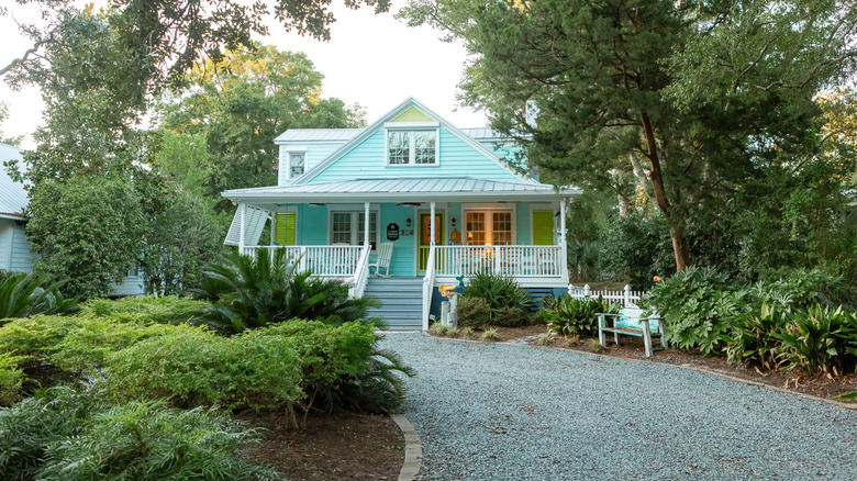 Light blue house with a gravel driveway