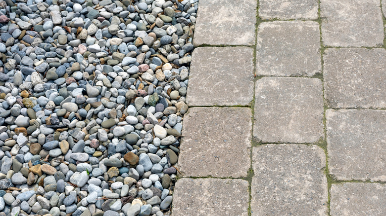 Larger pea gravel lining a brick path