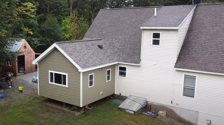 large two-story house with DIY room addition