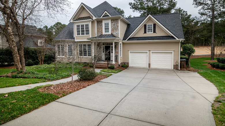 Suburban house with concrete walkway and widened driveway