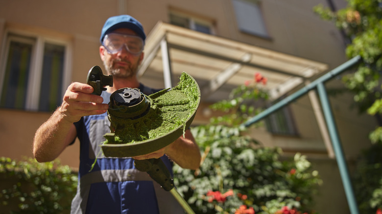 Gardener replacing the head on a string trimmer.