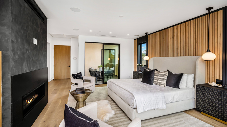 This luxurious bedroom has a wooden slatted accent wall.