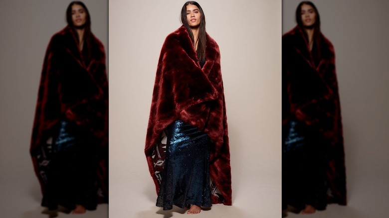 Woman wearing red faux fur blanket