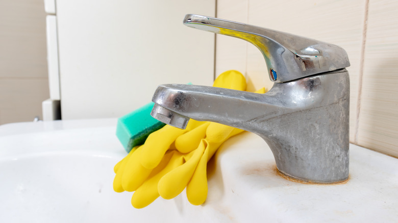 Dirty faucet with rust stains