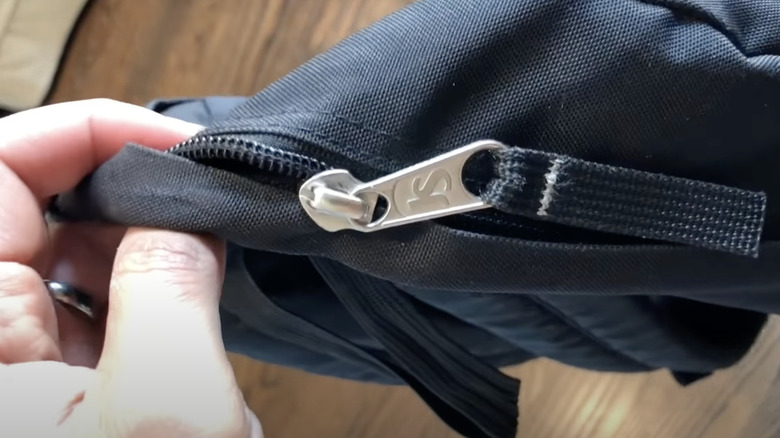 examining a stuck zipper